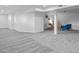 Finished basement area with light gray carpet and a partial view of a ' play area at 25 High St, Palmer Lake, CO 80133