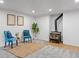 Cozy finished basement area featuring a wood-burning stove, blue upholstered chairs, and recessed lighting at 25 High St, Palmer Lake, CO 80133