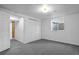 Finished basement with light, neutral colored carpet and an open doorway at 25 High St, Palmer Lake, CO 80133