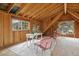 Bright bonus room featuring wood-paneled walls, large windows, and seating for relaxing at 25 High St, Palmer Lake, CO 80133