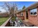Brick house outdoor deck furnished with modern seating and a view of the backyard at 25 High St, Palmer Lake, CO 80133