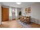 Dining room features natural light, a wooden table set for four, and light hardwood floors at 25 High St, Palmer Lake, CO 80133