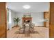 Elegant dining room with wood floors, a brick fireplace, and a table set for six guests at 25 High St, Palmer Lake, CO 80133
