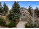 Charming home with a well-kept lawn, mature trees, and an attached garage, near a mountain at 25 High St, Palmer Lake, CO 80133