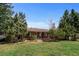 Charming single-story brick home featuring a well-manicured front lawn and mature landscaping at 25 High St, Palmer Lake, CO 80133