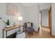 Cozy hallway with light-colored walls, wooden floors, accent furniture, and a view down the hall at 25 High St, Palmer Lake, CO 80133