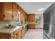 Kitchen with ample wood cabinetry, and stainless steel appliances with views of backyard from a garden window at 25 High St, Palmer Lake, CO 80133