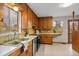 Charming kitchen with wood cabinets, a double basin sink, and a vintage aesthetic with modern appliances at 25 High St, Palmer Lake, CO 80133
