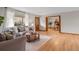Bright living room with a large window, plush sofa, wood floors, and a doorway to a dining area at 25 High St, Palmer Lake, CO 80133