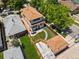 An aerial view of the backyard with a patio set, manicured lawn, wooden fence, and a detached garage at 400 S Gilpin St, Denver, CO 80209