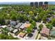 An aerial view of the neighborhood showcasing mature trees and landscaping with a view of nearby buildings at 400 S Gilpin St, Denver, CO 80209
