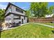 Spacious backyard featuring a patio, outdoor dining, manicured lawn, and mature trees at 400 S Gilpin St, Denver, CO 80209