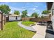 Beautiful backyard featuring a patio, dining set, manicured lawn, and storage building at 400 S Gilpin St, Denver, CO 80209