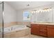 Bathroom featuring a jacuzzi tub, dual sink vanity, and tile flooring at 400 S Gilpin St, Denver, CO 80209