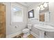 Clean bathroom with pedestal sink, earth-toned tile, and natural light from window at 400 S Gilpin St, Denver, CO 80209