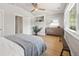 Bright bedroom boasts a ceiling fan, hardwood floors, and natural light from large windows at 400 S Gilpin St, Denver, CO 80209
