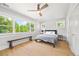 Bright bedroom with large windows, light wood floors, and a stylish seating bench at 400 S Gilpin St, Denver, CO 80209