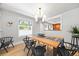 Bright dining room with light hardwood floors, modern chandelier, and views into another living space at 400 S Gilpin St, Denver, CO 80209