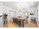 Bright dining room with modern light fixture, wooden table, and access to living spaces at 400 S Gilpin St, Denver, CO 80209