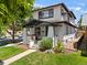 Two-story home featuring a covered porch, neat landscaping, and a well-manicured lawn on a sunny day at 400 S Gilpin St, Denver, CO 80209