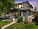 Two-story home featuring a covered porch, neat landscaping, and a well-manicured lawn on a sunny day at 400 S Gilpin St, Denver, CO 80209