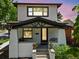 Inviting home boasting a covered porch with black accents, white brick pillars, and colorful potted flowers at 400 S Gilpin St, Denver, CO 80209