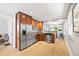 Open kitchen with wood cabinets, stainless appliances, and sight lines to dining area at 400 S Gilpin St, Denver, CO 80209