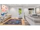 Bright living room with light hardwood floors, a decorative rug, a comfortable sofa, and a view to the outside at 400 S Gilpin St, Denver, CO 80209