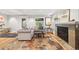Bright living room with light hardwood floors, a fireplace, comfortable seating, and natural light at 400 S Gilpin St, Denver, CO 80209