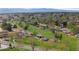 An aerial view of a neighborhood park featuring green space, mature trees, playground and walking paths at 1155 W 4Th Ave, Broomfield, CO 80020