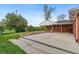 The backyard has lush green grass, stone features, and a covered patio area at 1155 W 4Th Ave, Broomfield, CO 80020
