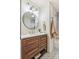 Stylish bathroom vanity with gold hardware, circular mirror, modern lighting, and decorative tile flooring at 1155 W 4Th Ave, Broomfield, CO 80020