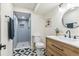 Stylish bathroom featuring a modern vanity, patterned tile floor, and glass-enclosed shower at 1155 W 4Th Ave, Broomfield, CO 80020