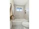 Updated bathroom featuring a shower-over-tub combination with vertically stacked white tiles and gold fixtures at 1155 W 4Th Ave, Broomfield, CO 80020