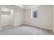 A serene bedroom featuring neutral colors, plush carpeting, and a bright window at 1155 W 4Th Ave, Broomfield, CO 80020