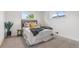 Bright bedroom with neutral decor, two windows, and soft carpet at 1155 W 4Th Ave, Broomfield, CO 80020