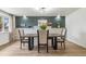 The dining room is decorated with a stone fireplace and dark green accent wall at 1155 W 4Th Ave, Broomfield, CO 80020