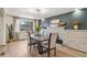 An open dining room boasts a stone fireplace, stylish decor, and lots of natural light at 1155 W 4Th Ave, Broomfield, CO 80020