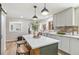 Bright, modern kitchen with a center island, quartz countertops, and a stylish backsplash at 1155 W 4Th Ave, Broomfield, CO 80020
