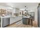 Newly renovated kitchen boasts modern cabinets, stylish backsplash, and center island with pendant lighting at 1155 W 4Th Ave, Broomfield, CO 80020