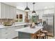 A gourmet kitchen with stone backsplash, stainless steel appliances, and a center island for food preparation at 1155 W 4Th Ave, Broomfield, CO 80020