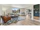 The living room features a large window, seating area, and view to the dining room at 1155 W 4Th Ave, Broomfield, CO 80020