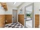 Mud room features wood-look wall paneling, checkered tile floor, and access to a covered patio at 1155 W 4Th Ave, Broomfield, CO 80020