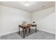 Functional office space with a wooden desk, chair, and ample lighting, perfect for productivity and focus at 1155 W 4Th Ave, Broomfield, CO 80020