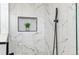 Close up of luxurious shower with marble tiles and a black shower head at 1155 W 4Th Ave, Broomfield, CO 80020