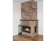 Brick fireplace with detailed brickwork and wooden mantel adds a cozy focal point to the living space at 1021 Carr St # 37, Lakewood, CO 80214