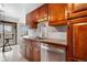 Contemporary kitchen featuring stainless steel appliances, sleek countertops, wood cabinets, and a view to the outdoor balcony at 1021 Carr St # 37, Lakewood, CO 80214