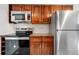 Updated kitchen with stainless steel appliances, sleek countertops, and wood cabinets offers a modern look at 1021 Carr St # 37, Lakewood, CO 80214