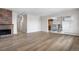 Open-concept living room leads to dining area with view of brick fireplace at 1021 Carr St # 37, Lakewood, CO 80214