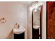 Bathroom featuring a sink and decorative mirror with modern lighting at 634 S Hazel Ct, Denver, CO 80219